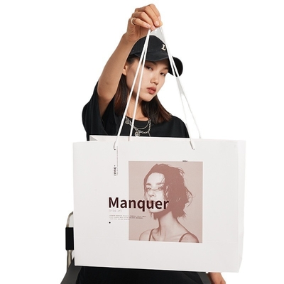 Borse della spesa di lusso premium in carta bianca stampata personalizzata con design a manico a nastro