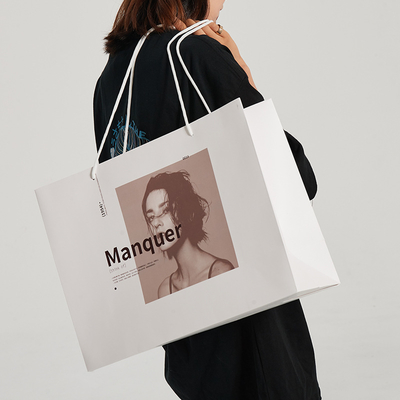 Borse della spesa di lusso premium in carta bianca stampata personalizzata con design a manico a nastro